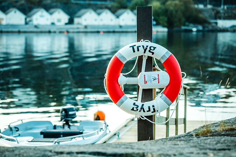 Tryg livbøyen som henger på brygge