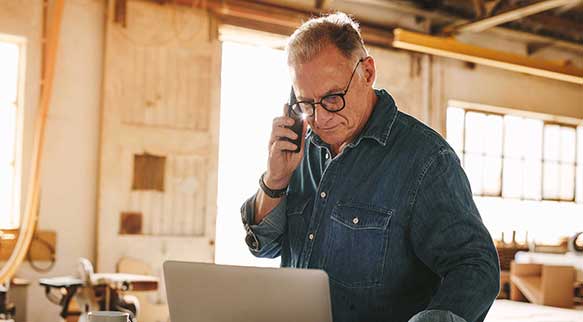 Mann snakker i telefonen på jobb 