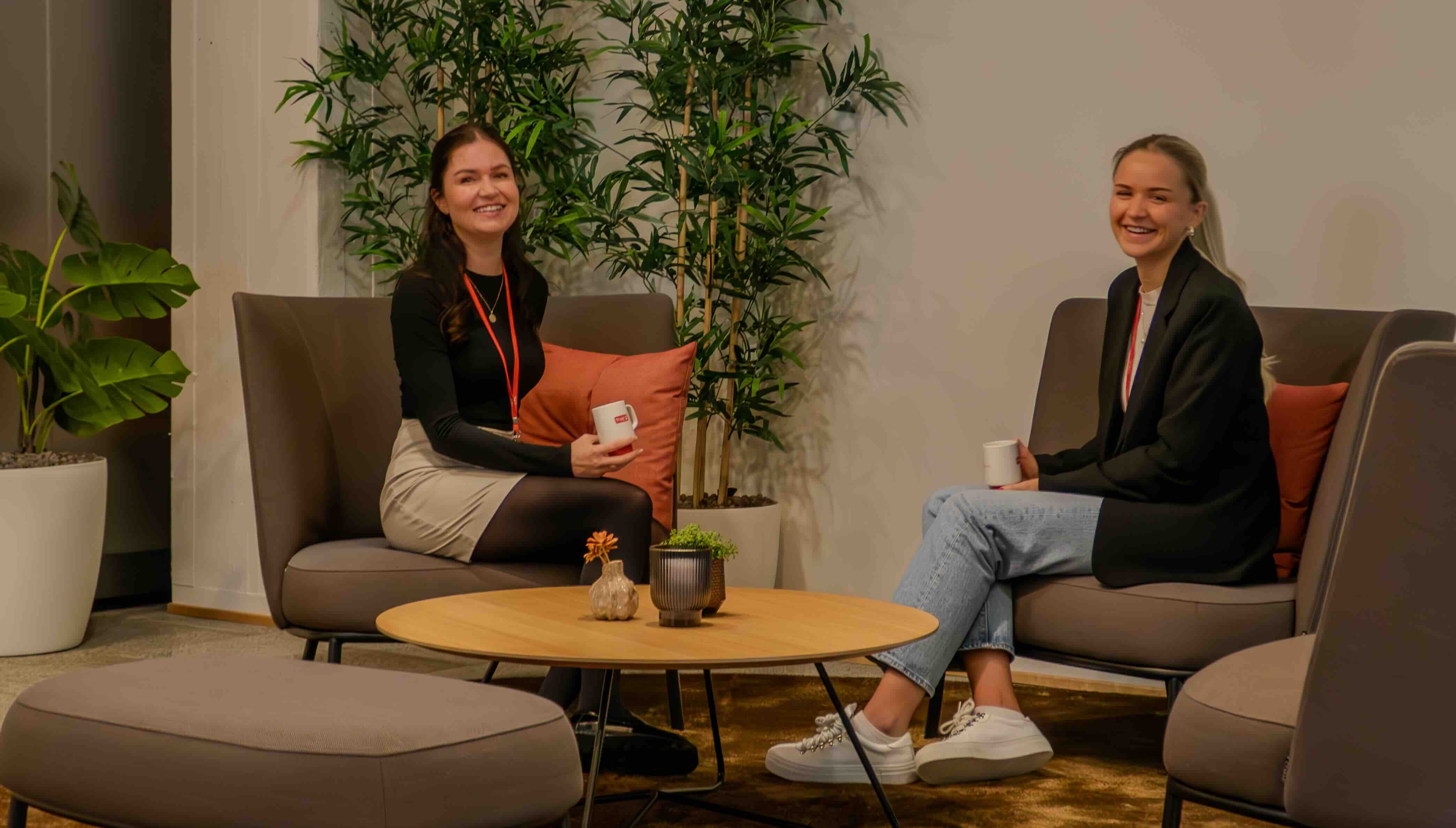 To rådgivere snakker sammen over en kopp kaffe.