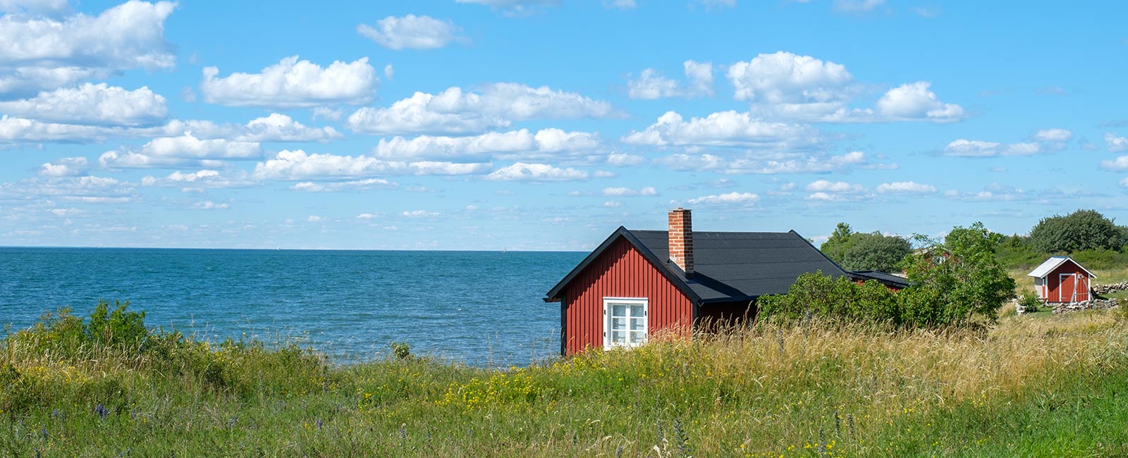 Rød hytte ved sjøen